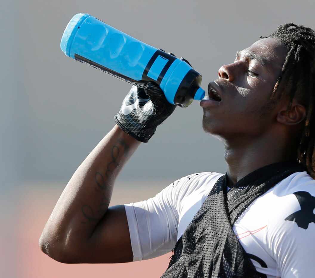 Carter's Justise Wade-Harris gets water after a series of run plays during the first day of...