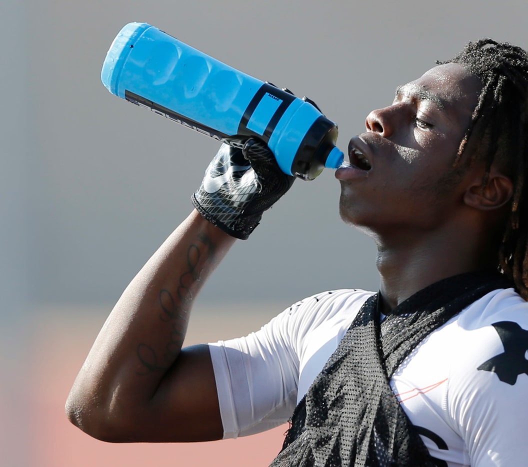 Carter's Justise Wade-Harris gets water after a series of run plays during the first day of...