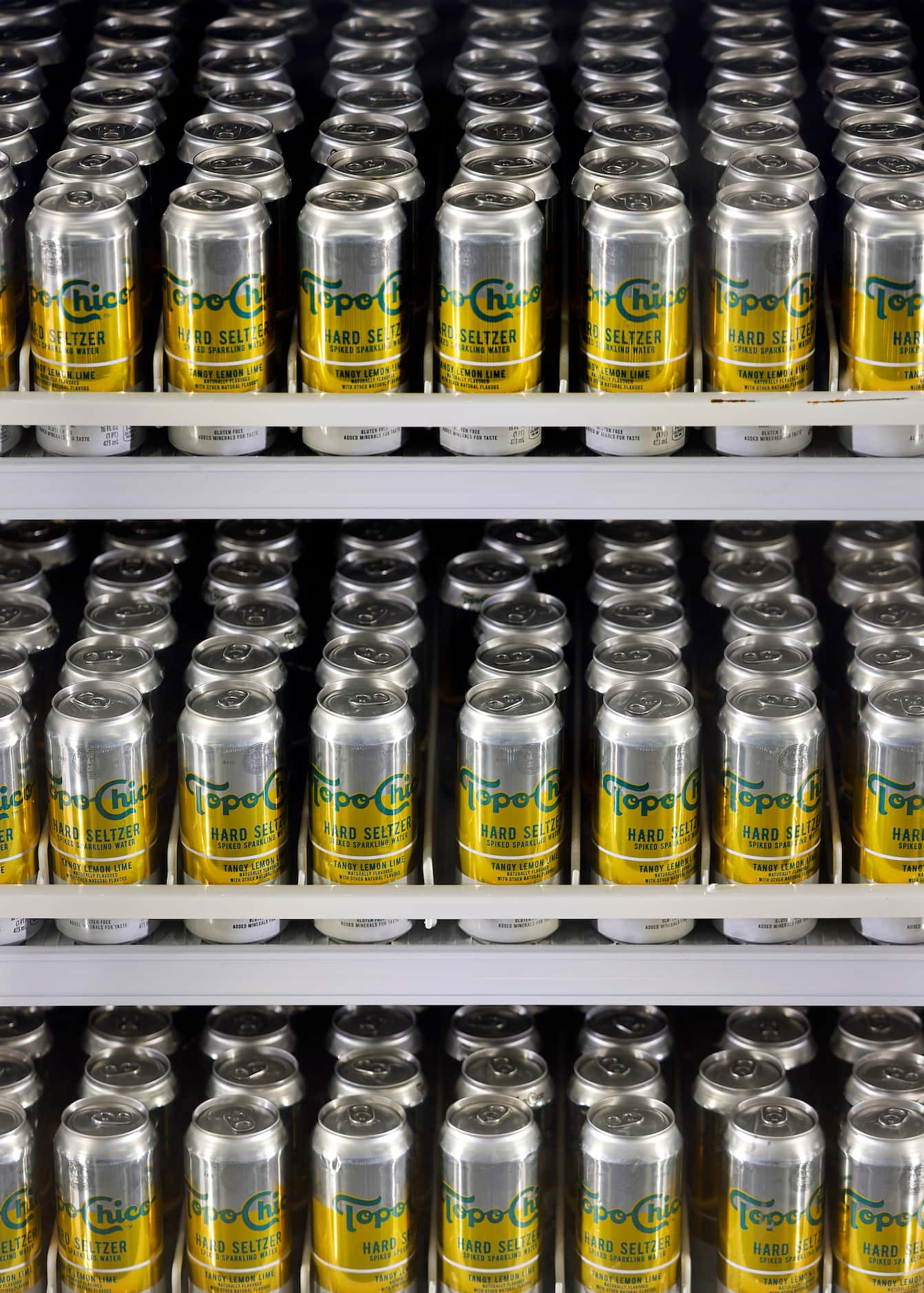 Cans of Topo Chico Hard Seltzer are packed into the Miller LiteHouse walk-in cooler on the...