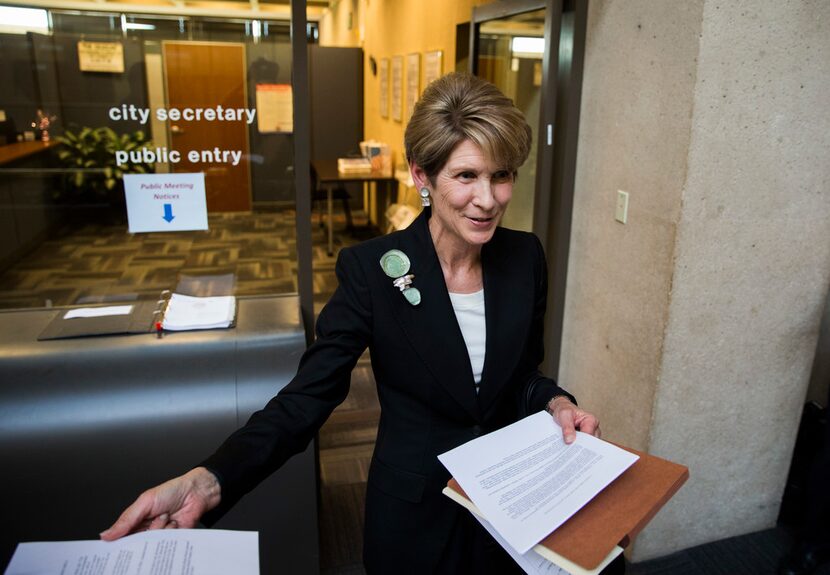 Former Dallas Mayor Laura Miller speaks to reporters as she leaves the City Secretary's...