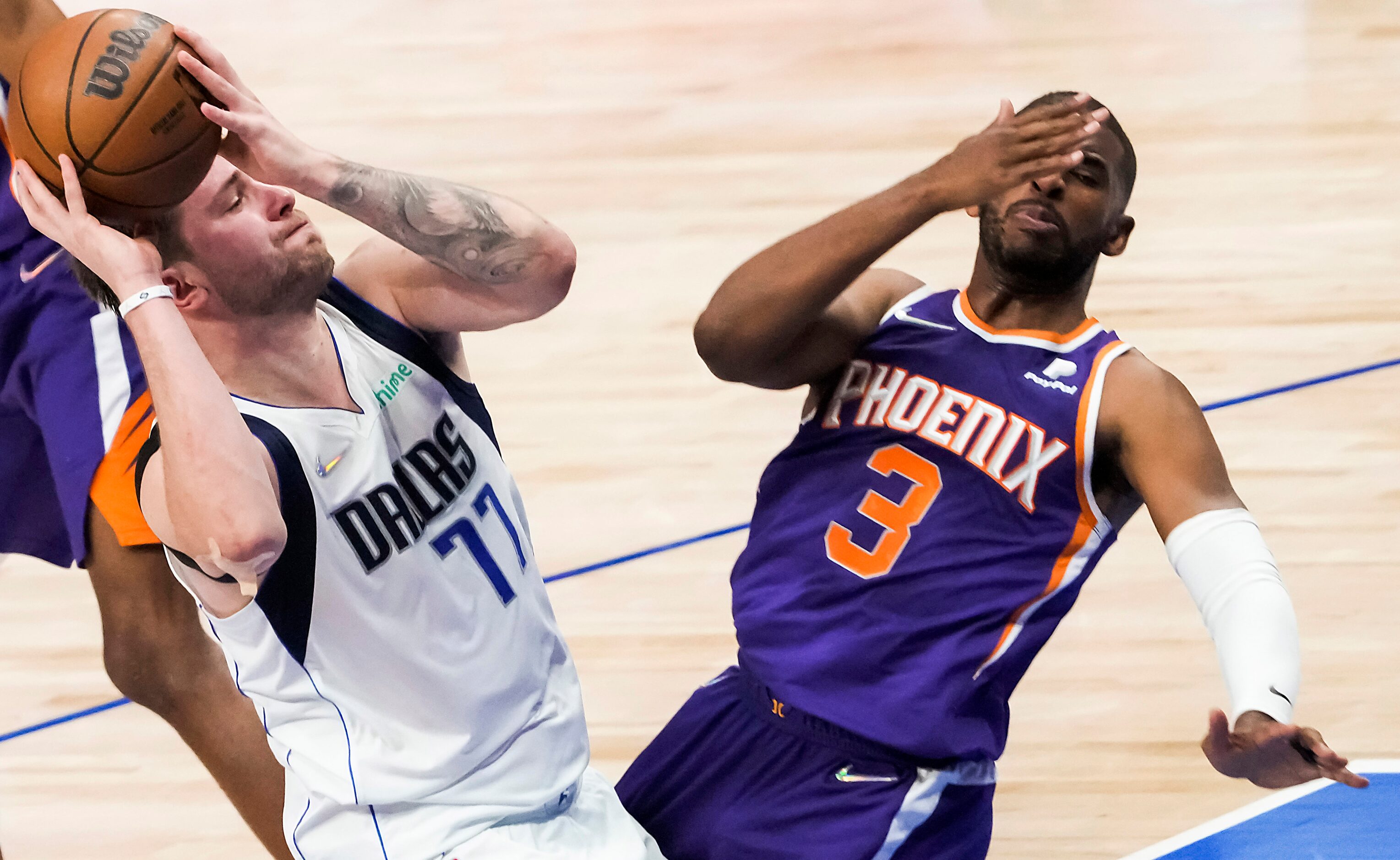 Phoenix Suns guard Chris Paul (3) falls backwards as he is fouled by Dallas Mavericks guard...