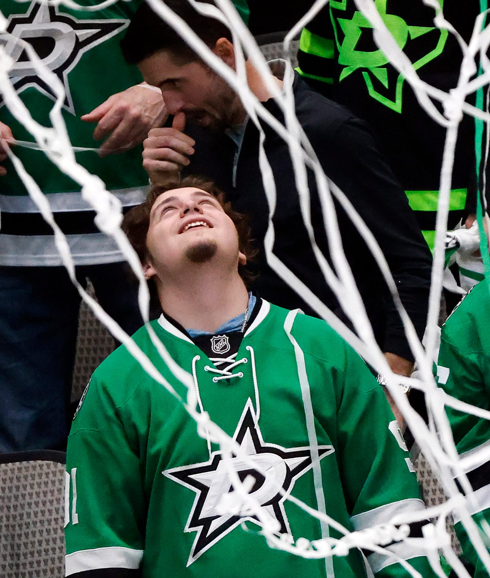 A Dallas Stars fan revels in the paper streamers falling following the teams 7-3 win over...