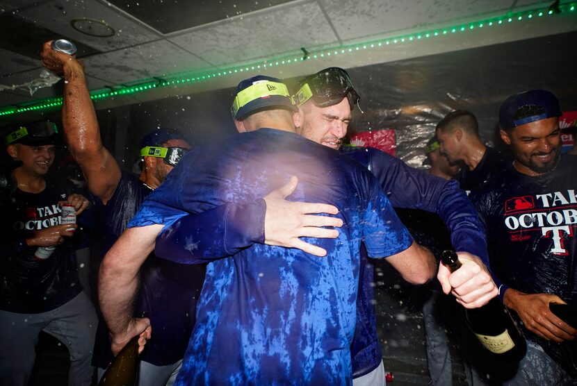 The Texas Rangers celebrate clinching a playoff spot in the American League after a 6-1 win...