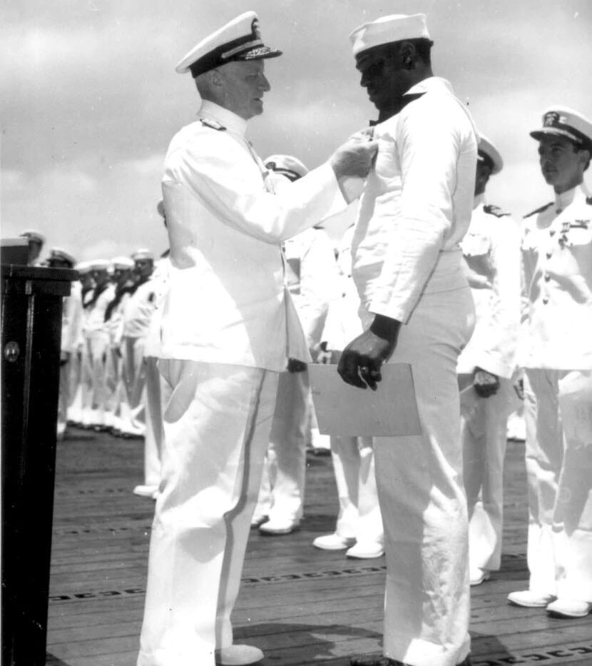 Admiral Chester Nimitz, the Commander in Chief, Pacific Fleet, pins Navy Cross on Doris...