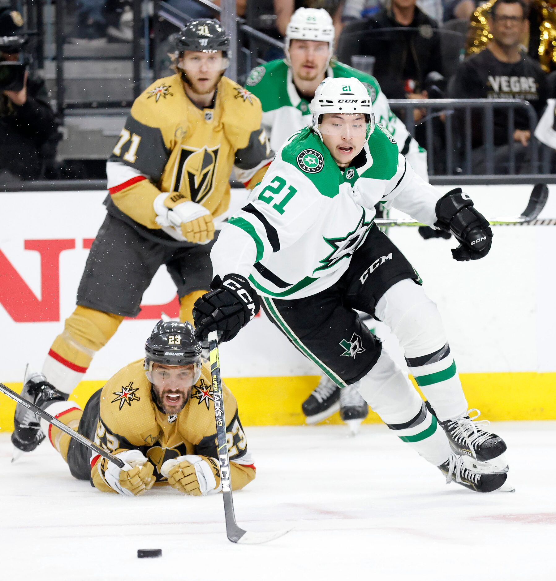 Dallas Stars left wing Jason Robertson (21) takes control of the puck after battling Vegas...