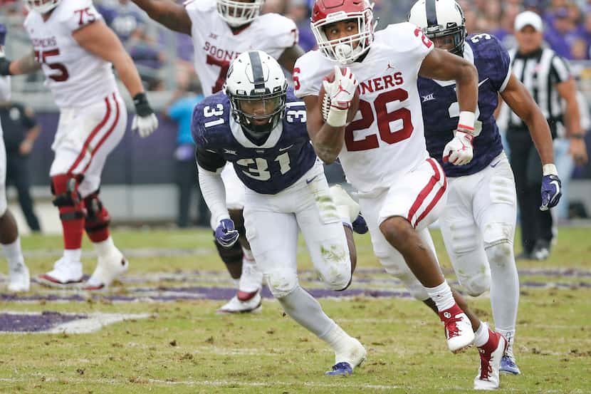 Oklahoma Sooners running back Kennedy Brooks (26) motors downfield on a long second-quarter...