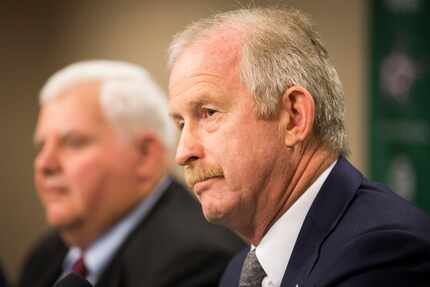 FILE - General manager Jim Nill listens as Ken Hitchcock addresses the media after being...