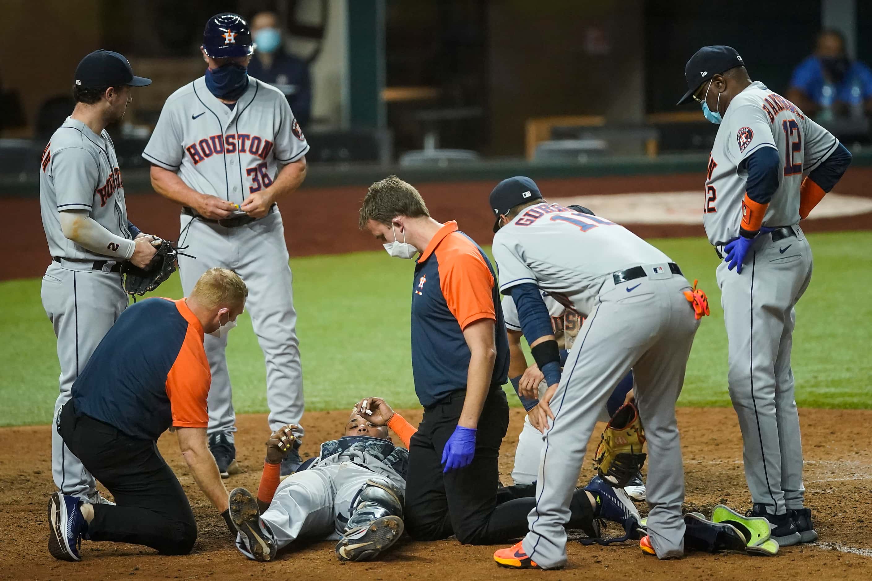 Houston Astros catcher Martin Maldonado receives attention after being injured on the final...