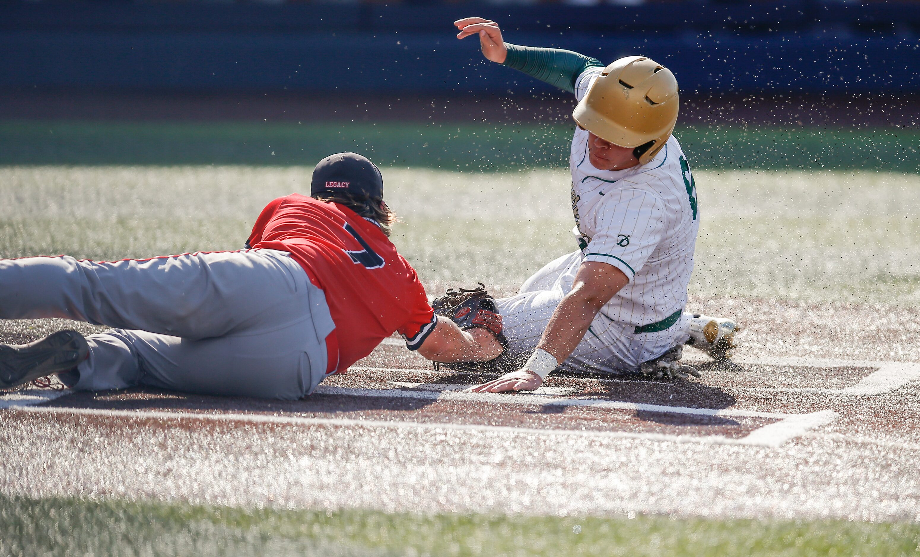 Mansfield Legacy pitcher Drake Dowd (7) is unable to make the tag as Birdville’s Bynum...