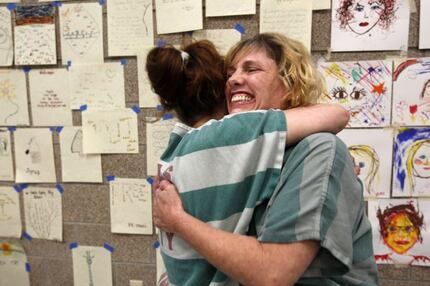 Dallas County prisoners hug during a rehabilitation program. 