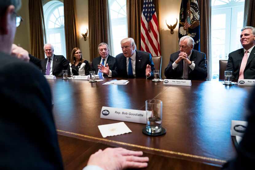 President Donald Trump with lawmakers during a bipartisan meeting on immigration this week...