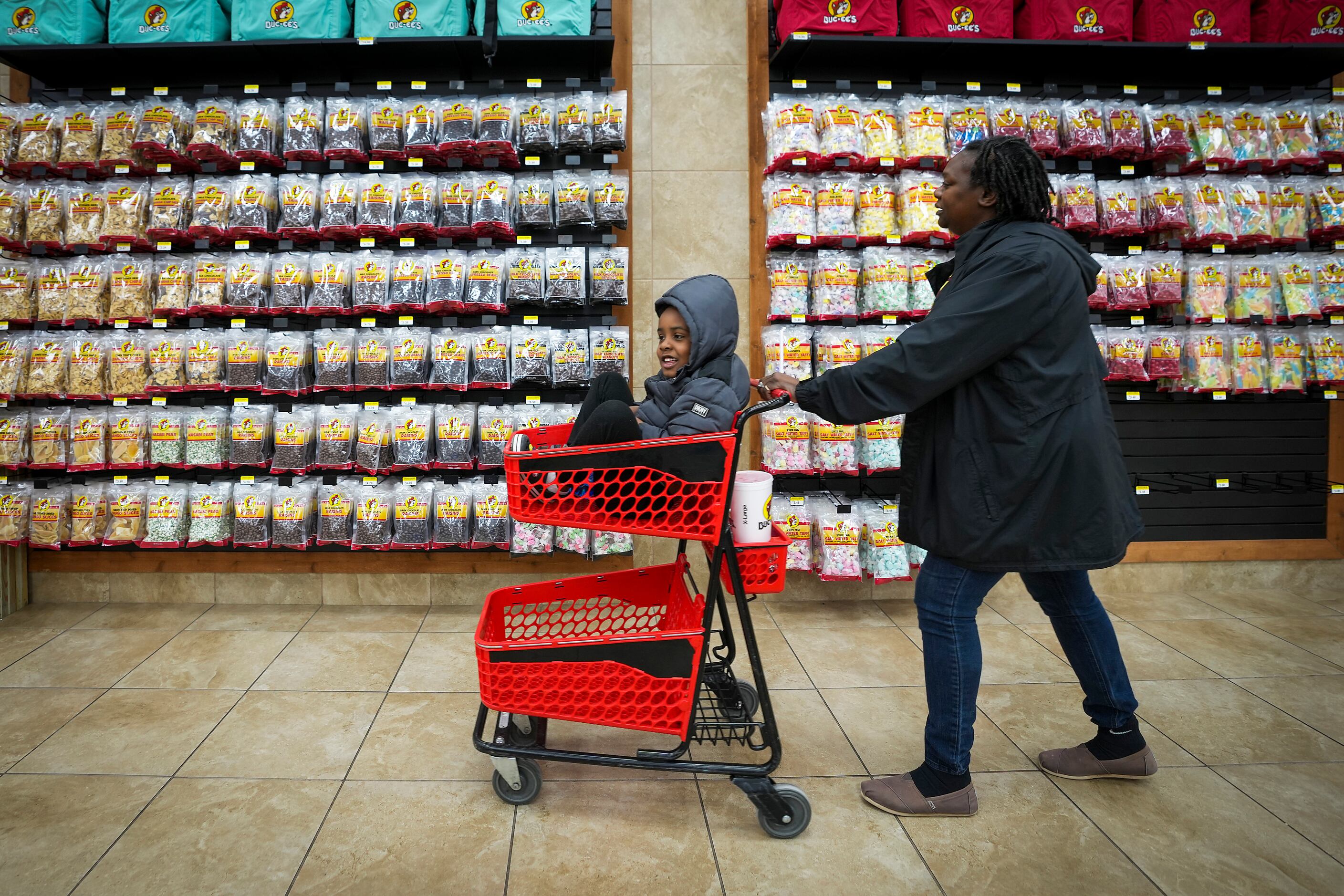 Mary Calhoun pushes her 4-year-old son Kyrie in a cart as they shop for snacks at Buc-ee's...