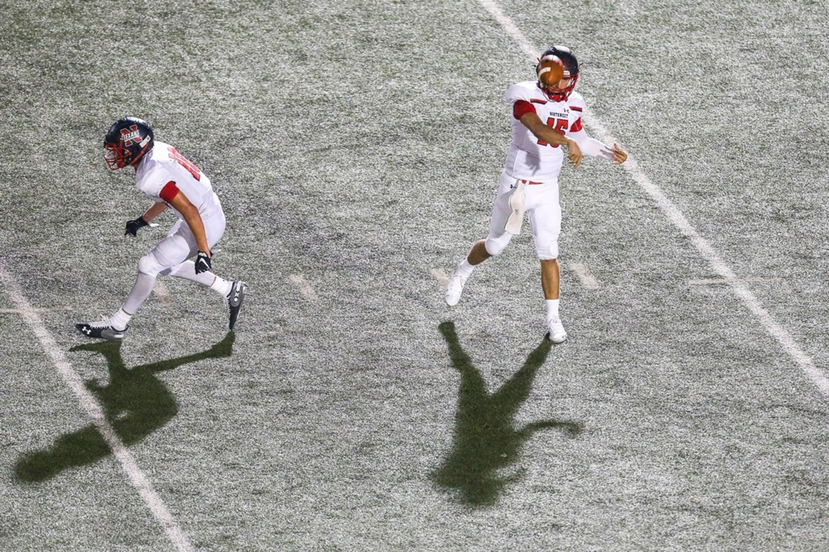 Northwest quarterback Austin Ahmad (15) makes a pass as running back Kyndel Sims protects...