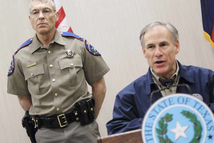 Texas Department of Public Safety Director Steve McCraw stands behind Texas Governor Greg...