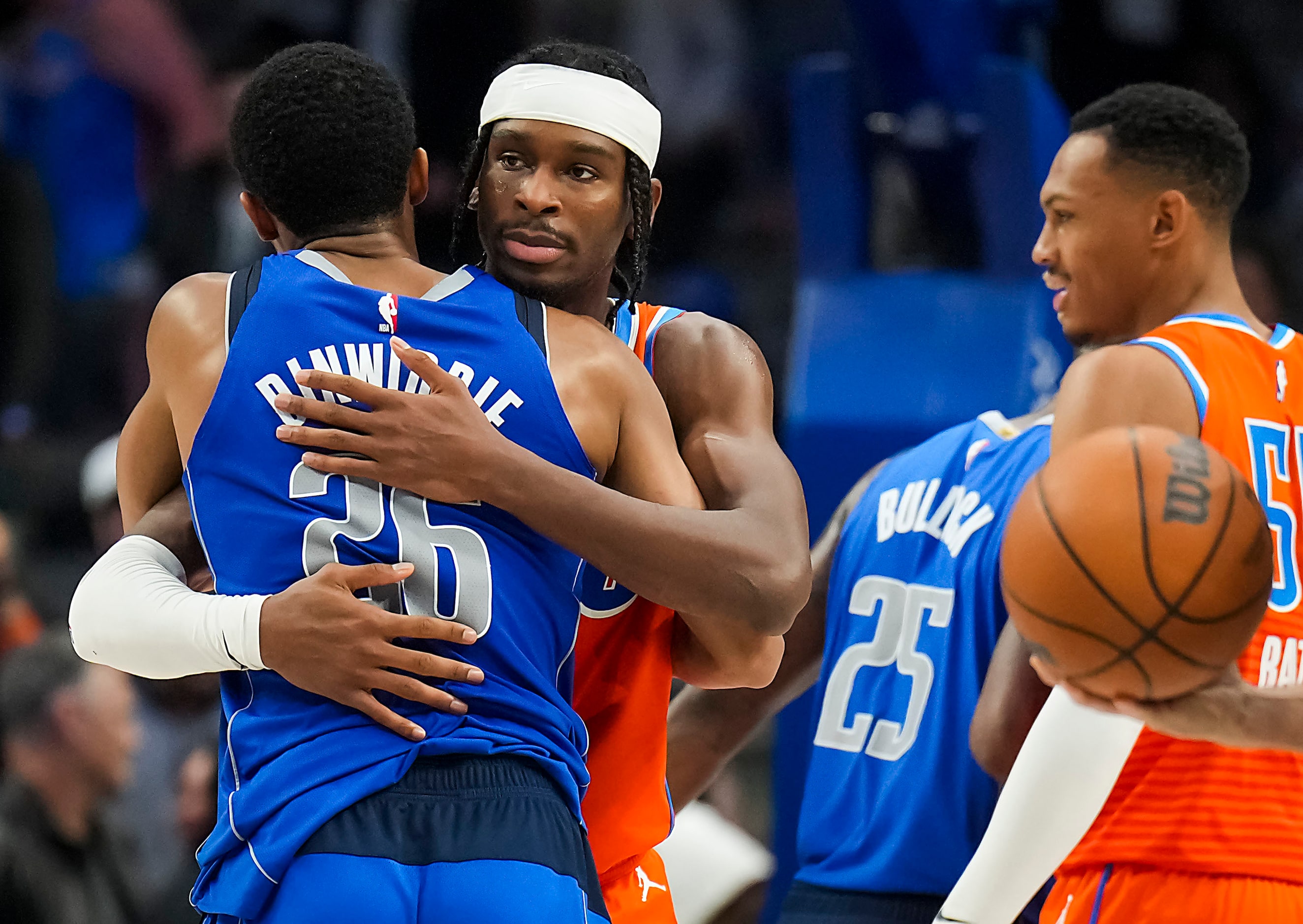 Oklahoma City Thunder guard Shai Gilgeous-Alexander hugs Dallas Mavericks guard Spencer...