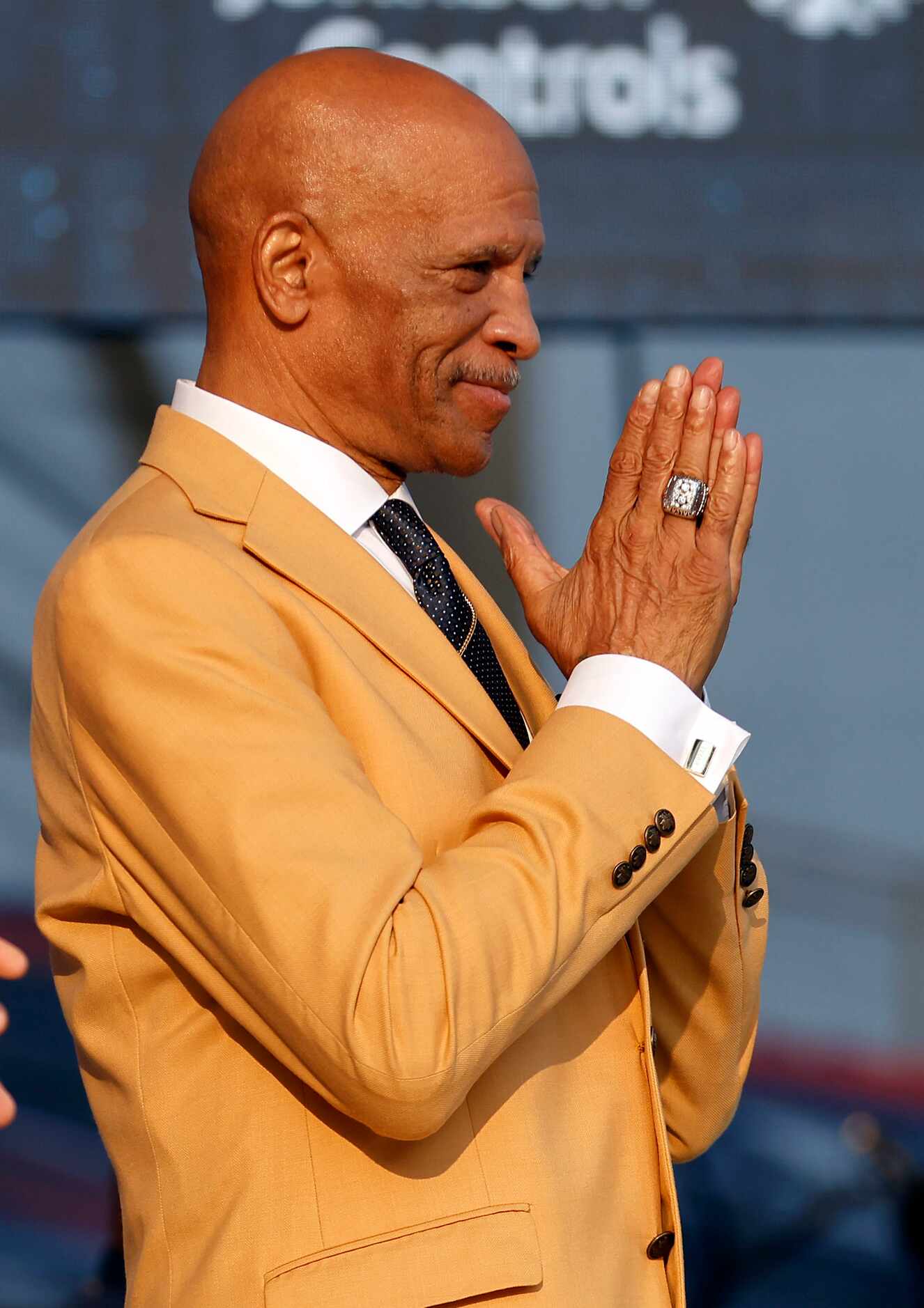 Pro Football Hall of Fame inductee Drew Pearson of the Dallas Cowboys acknowledges the...