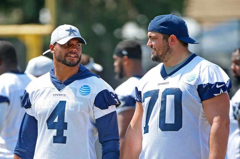 Dallas Cowboys quarterback Dak Prescott, left, talks with guard Zack Martin during the...