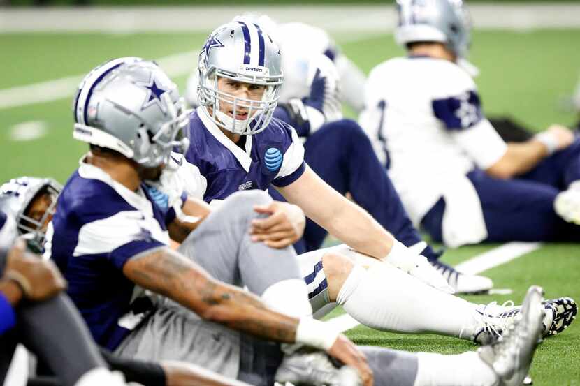 Dallas Cowboys linebacker Sean Lee (center) stretches with teammates before practice at The...