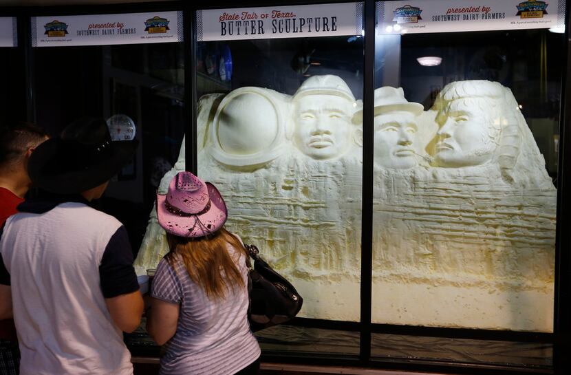 People look at the "Mount Muchmore" butter sculpture at the State Fair of Texas in Dallas on...