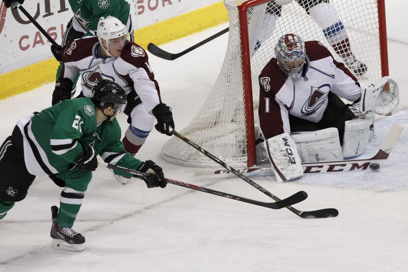 Dallas Stars left wing Antoine Roussel's (21) shot gets blocked by Colorado Avalanche goalie...