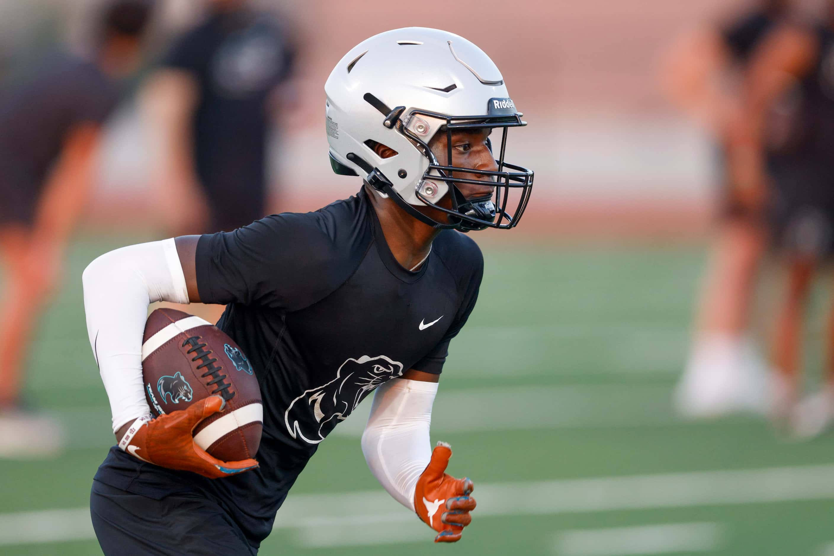 Wide receiver Jalen Lott runs after a catch during an early morning practice at Panther...