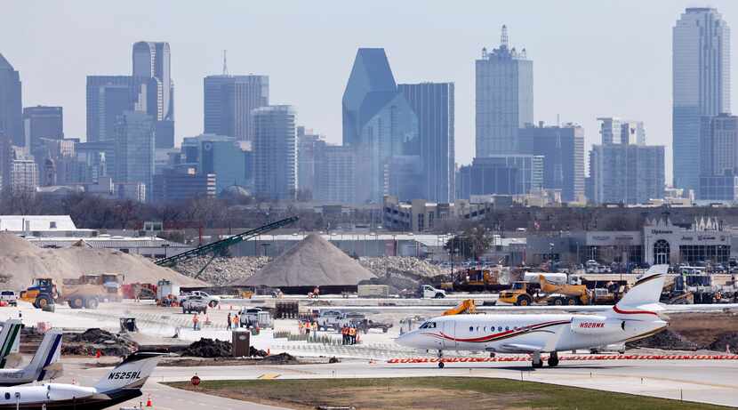 A private jet taxis to a hanger as crews continue to reconstruct runway 13R-31L and taxiway...