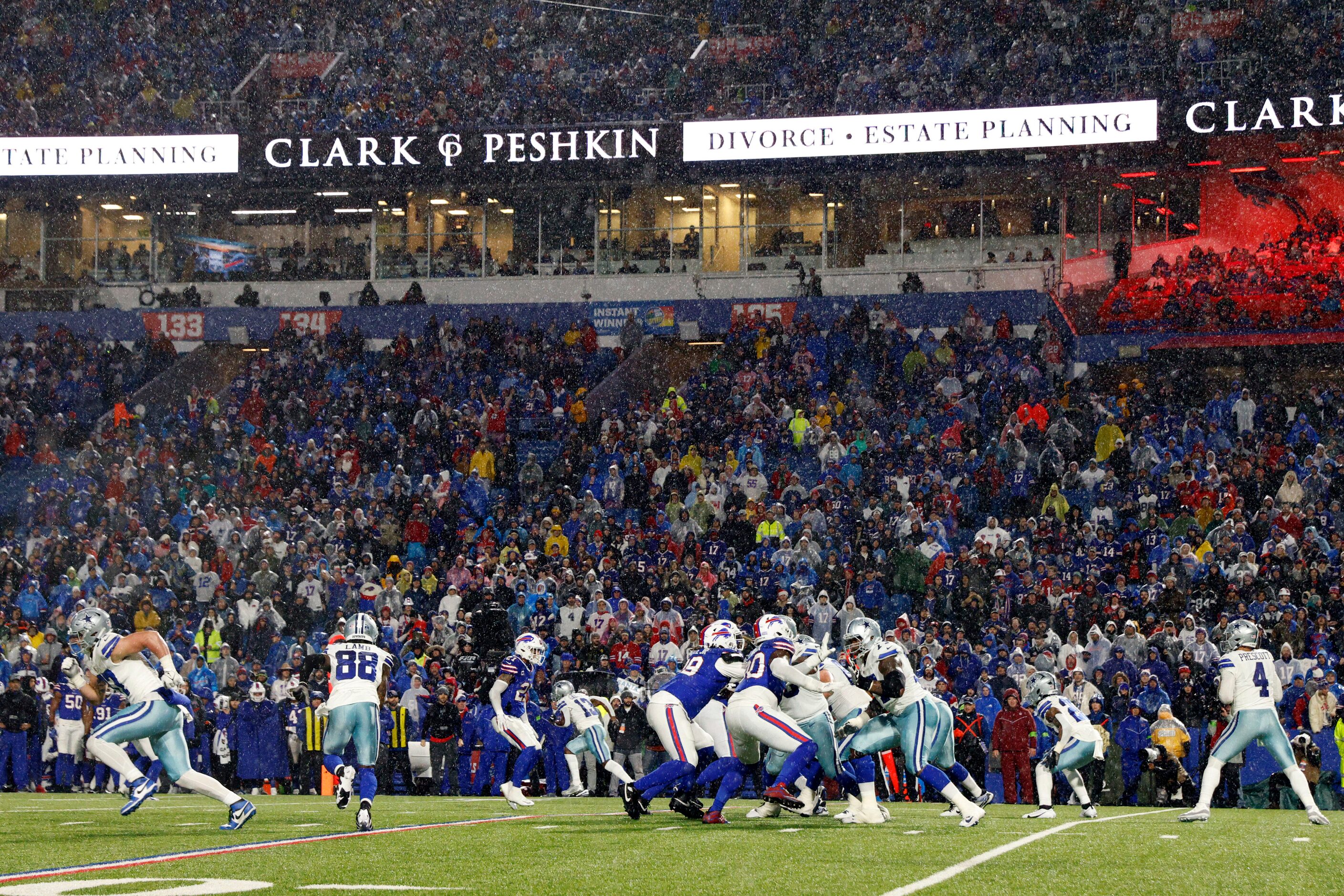 Dallas Cowboys quarterback Dak Prescott (4) drops back to pass as rain falls during the...