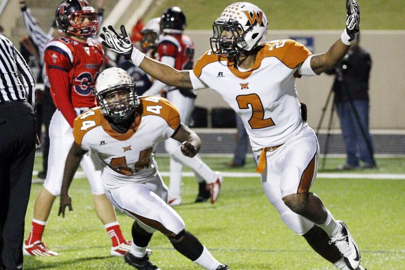 West Mesquite High QB Kameron Miles (2) and Nathaniel Roseburrow (44) celebrate, after...
