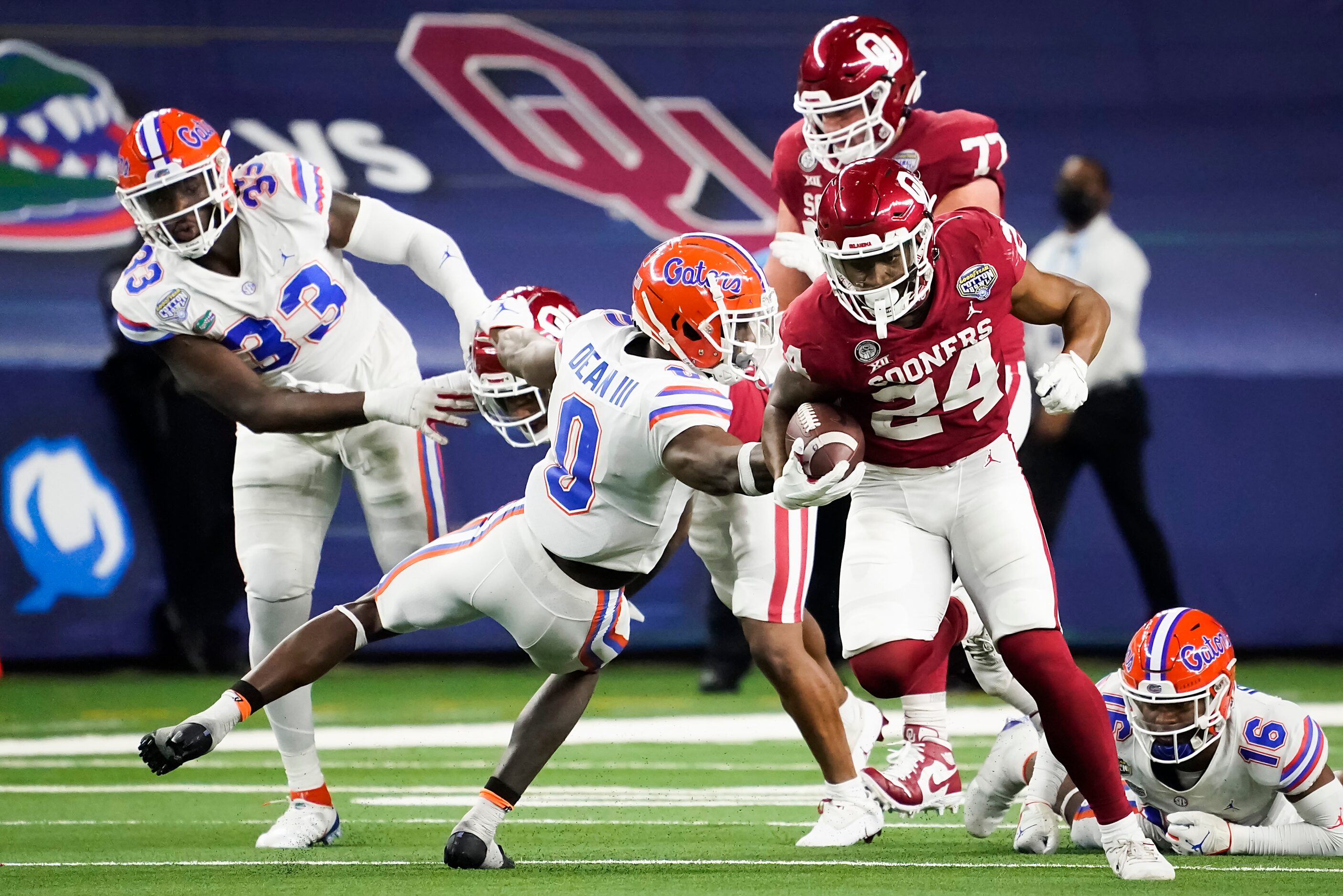 Oklahoma running back Marcus Major (24) gets past Florida defensive back Trey Dean III (0)...