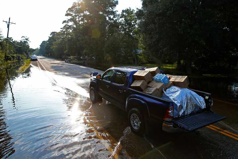 A truck loaded with donated materials leaves the drop-off point on the west end of Pine...