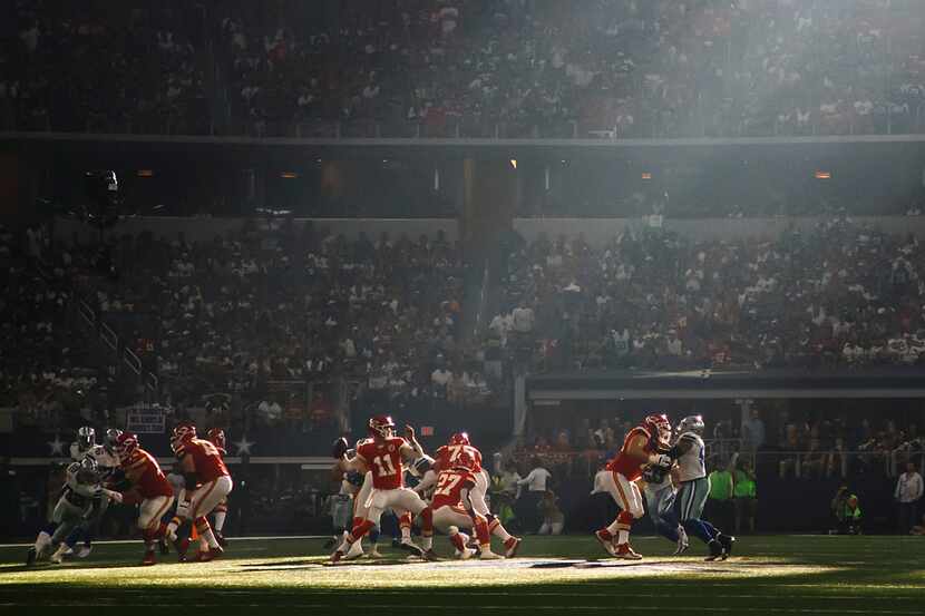 Kansas City Chiefs quarterback Alex Smith (11) gets off a pass as sunlight filters into the...