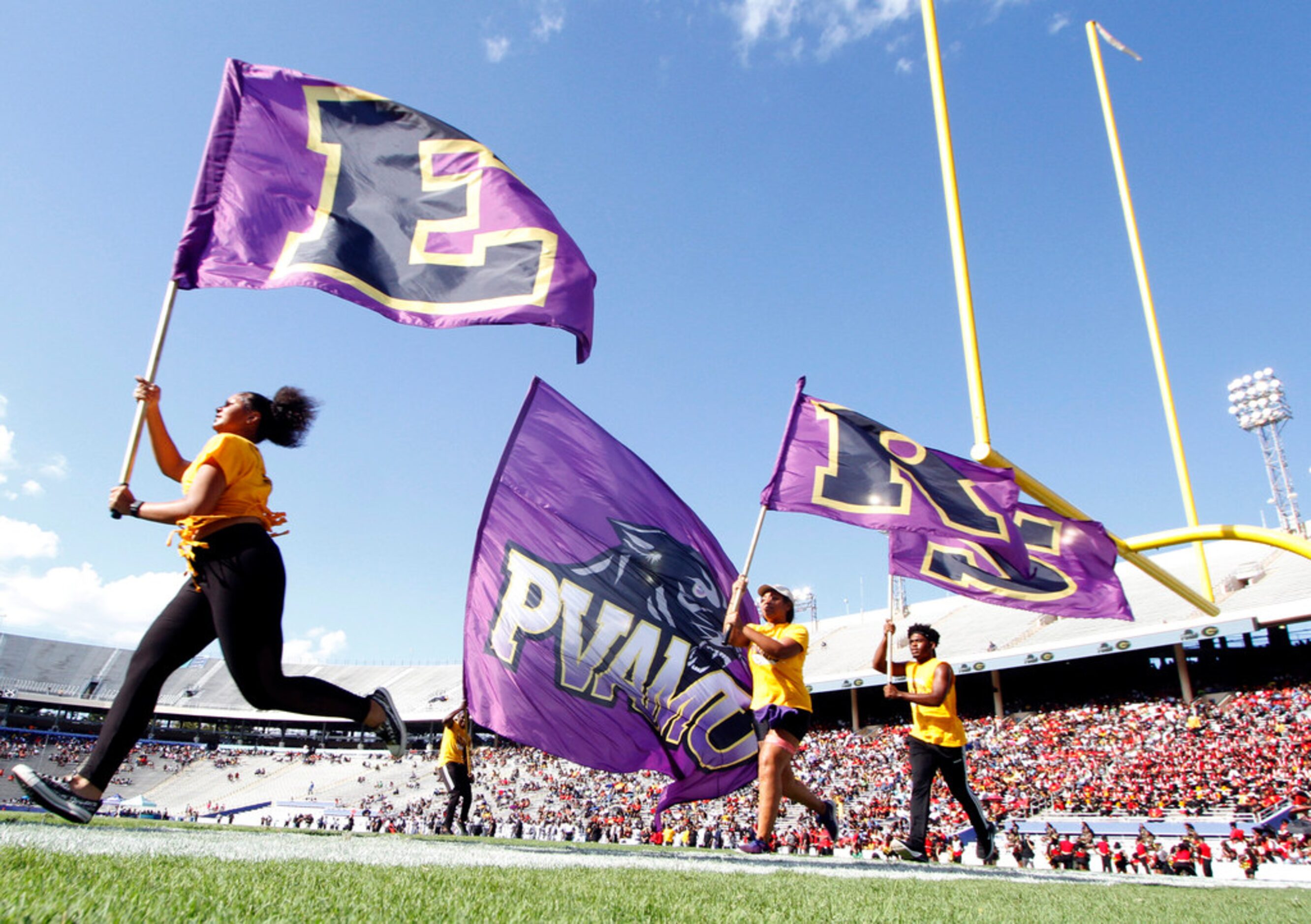 Members of a Prairie View spirit squad celebrate a first quarter touchdown in their game...