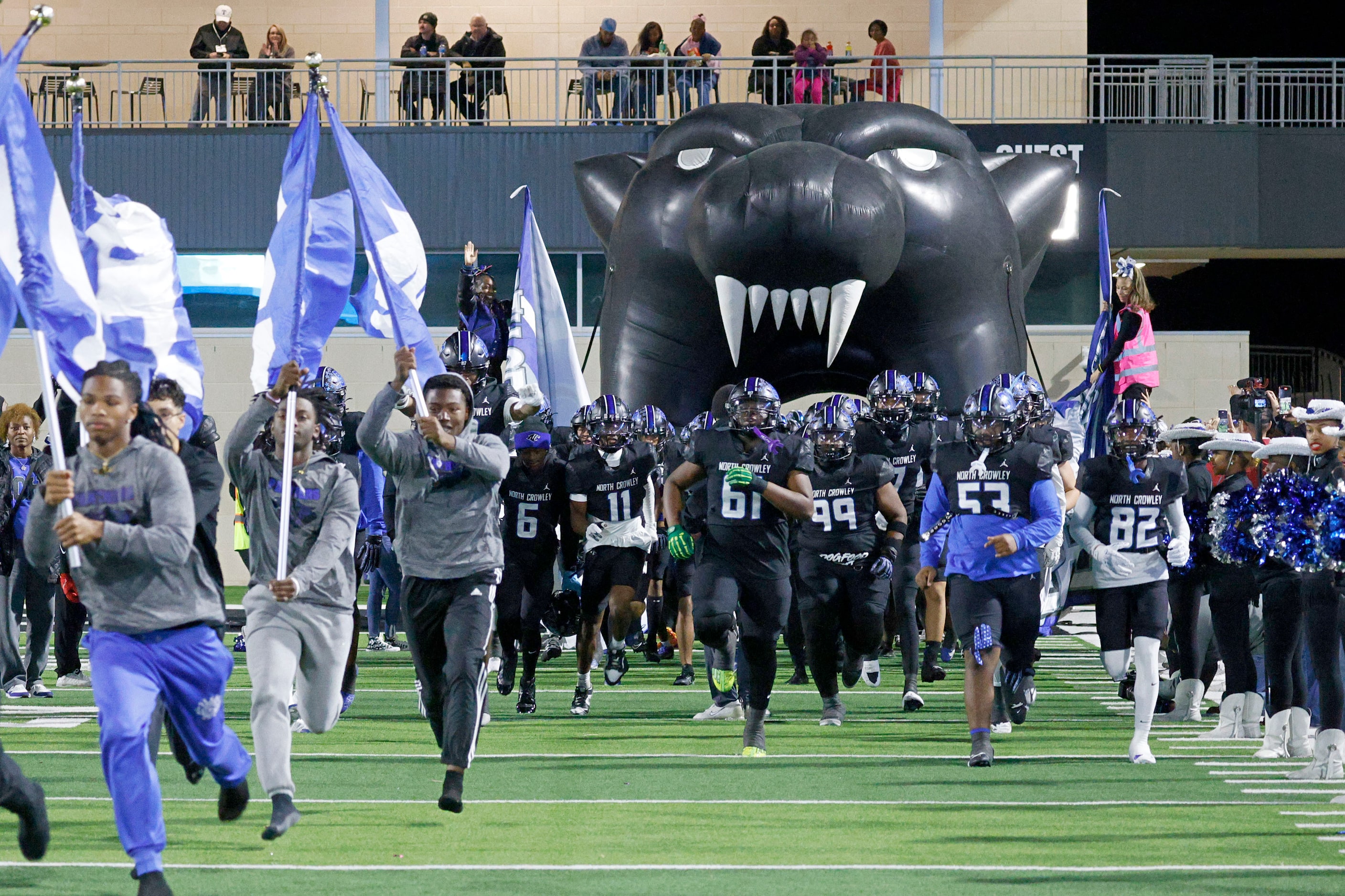 North Crowley’s players run out to the field before a high school football game against...