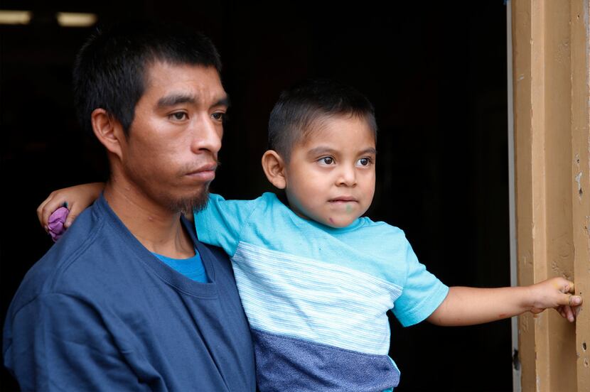 Pablo Ortiz, 28, with his son Andres, 3, speaks to at the Annunciation House in El Paso on...