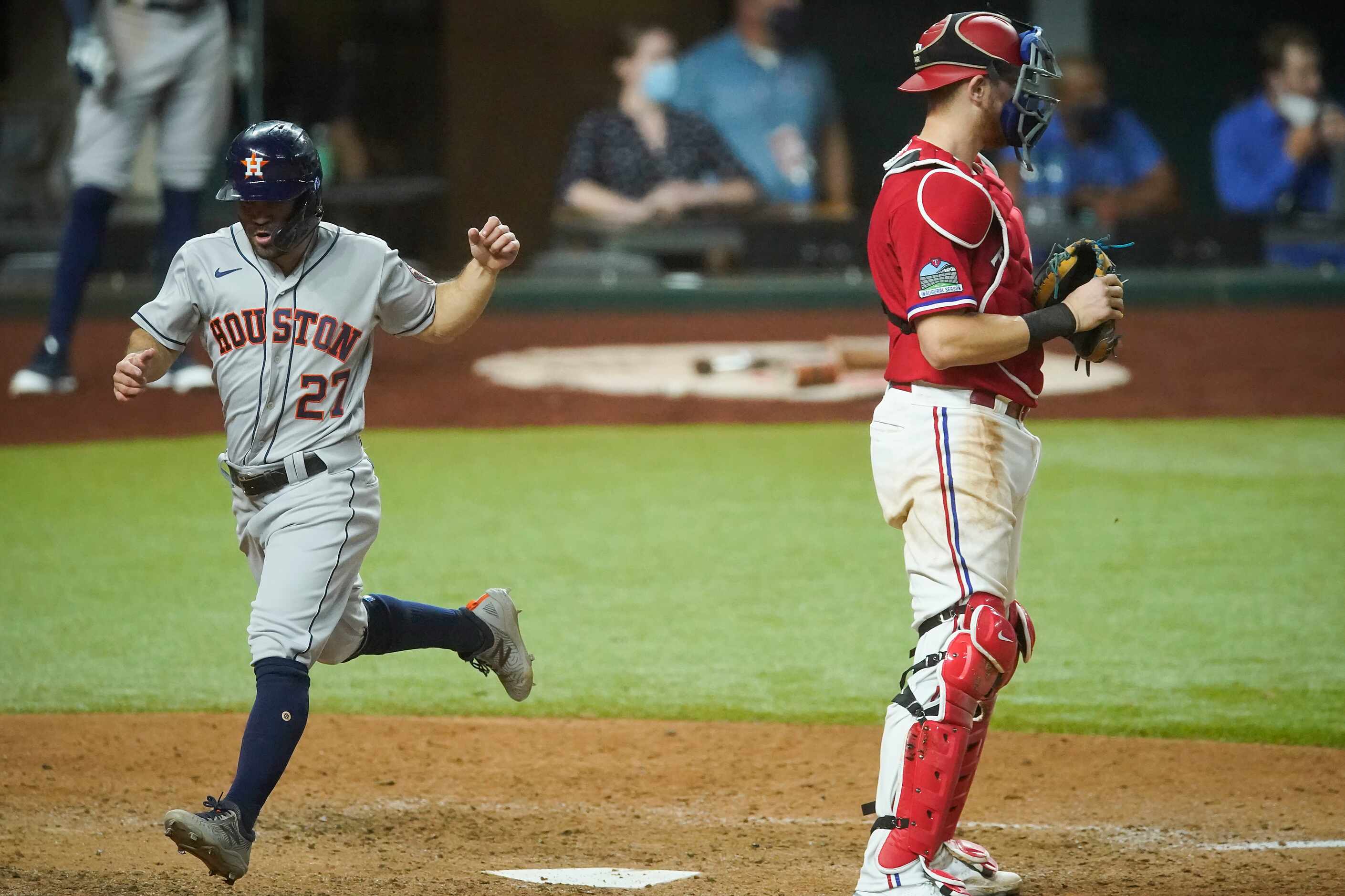 Houston Astros second baseman Jose Altuve scores past Texas Rangers catcher Sam Huff on a...