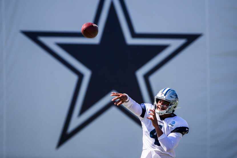Dallas Cowboys quarterback Dak Prescott (4) throws a pass during an afternoon practice at...