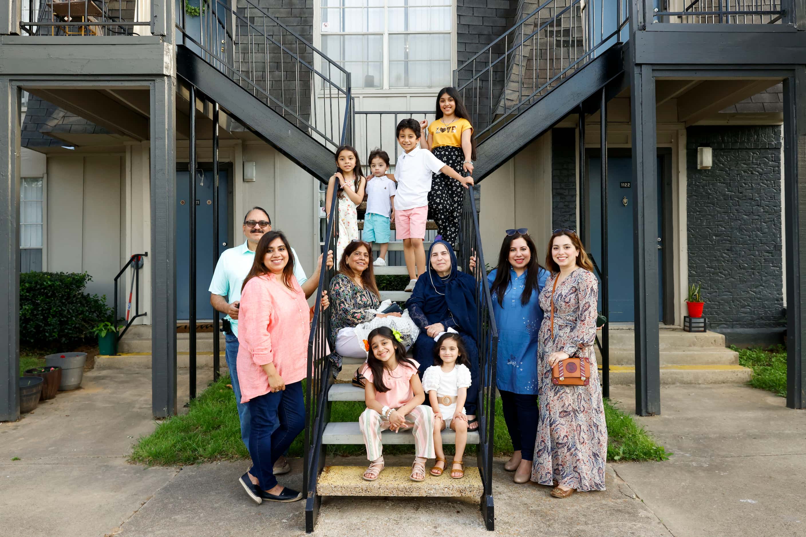 Former Wingren Village Apartments residents Mohammed Humayoun Butt (back left), his daughter...