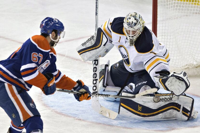 Buffalo Sabres goalie Jhonas Enroth (1) makes the save on Edmonton Oilers' Benoit Pouliot...