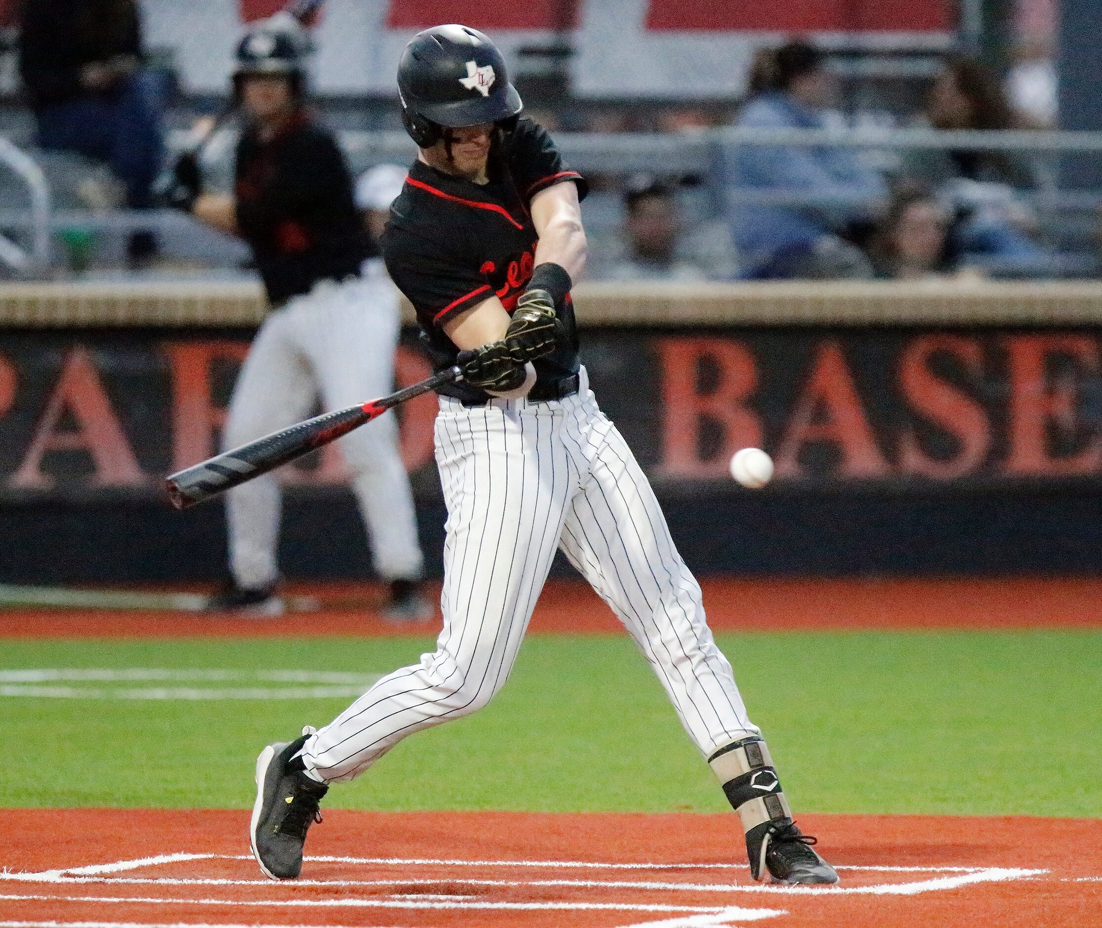 Lovejoy High School left fielder Trent Rucker (2) makes contact in the second inning as...