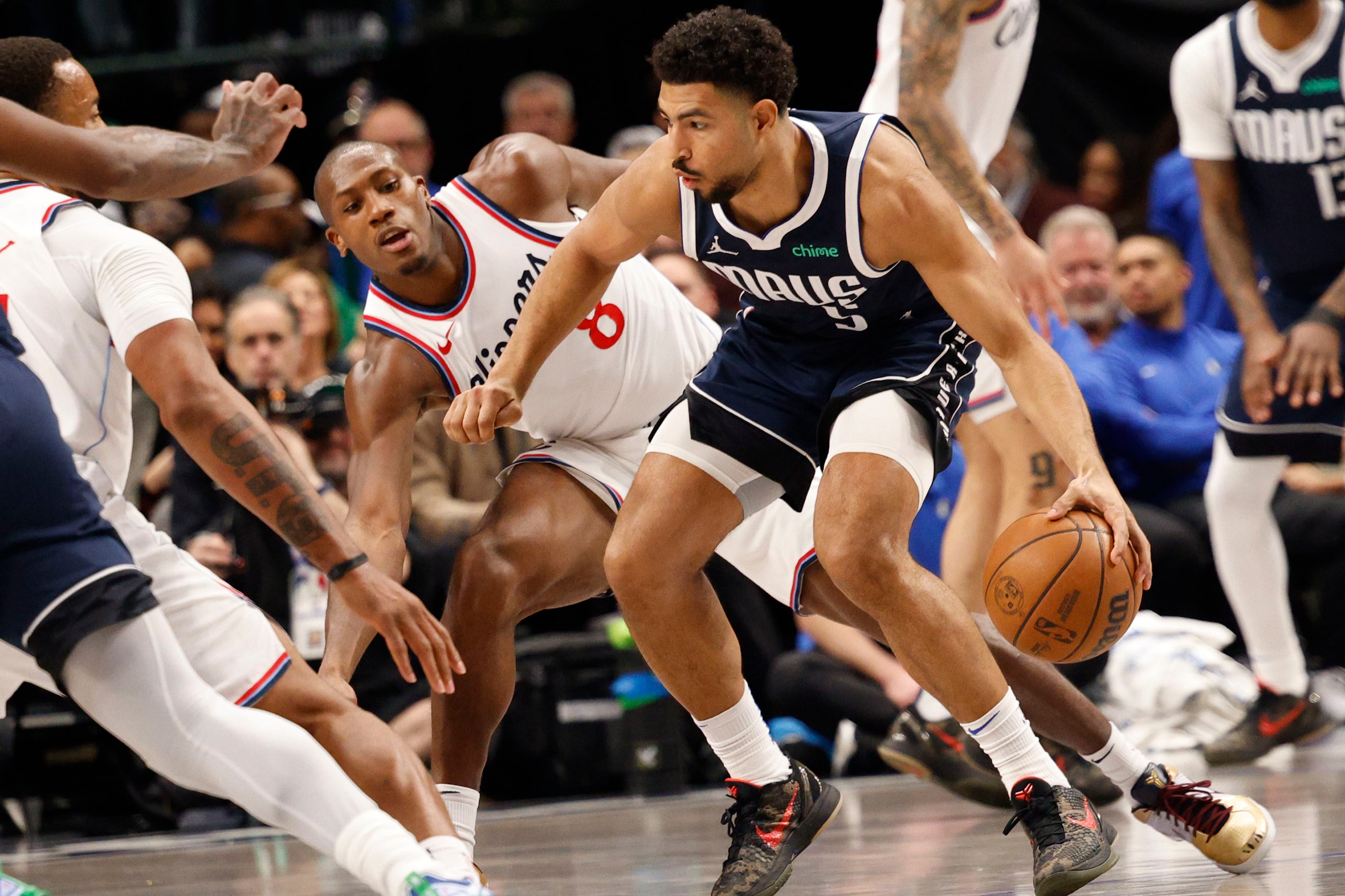 Dallas Mavericks guard Quentin Grimes (5) tries to drive past LA Clippers guard Kris Dunn...