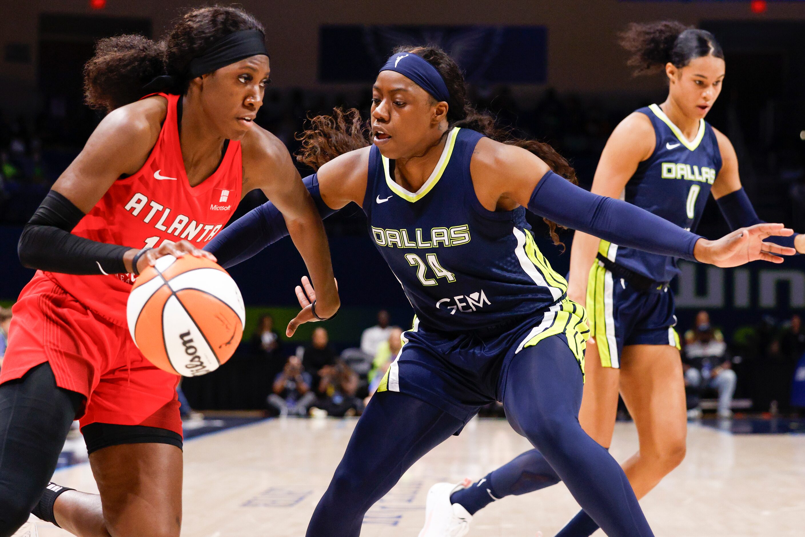 Dallas Wings guard Arike Ogunbowale (24) defends against a driving Atlanta Dream guard Rhyne...