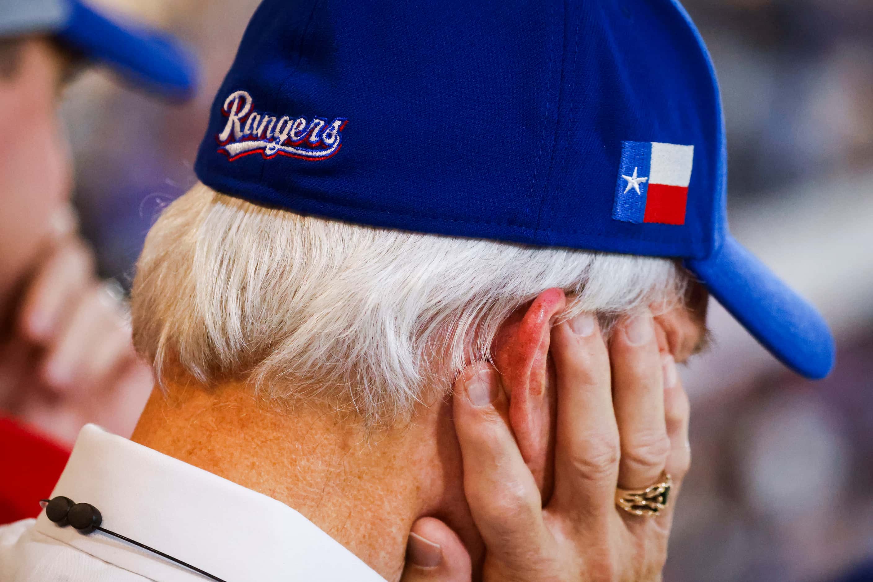 A Texas Rangers fan watches during the eleventh inning of Game 1 of the World Series against...