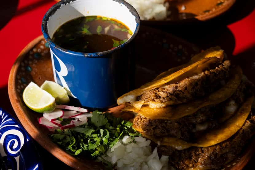 A plate of quesabirria is served with consomme at Maskaras Mexican Grill, in Dallas.