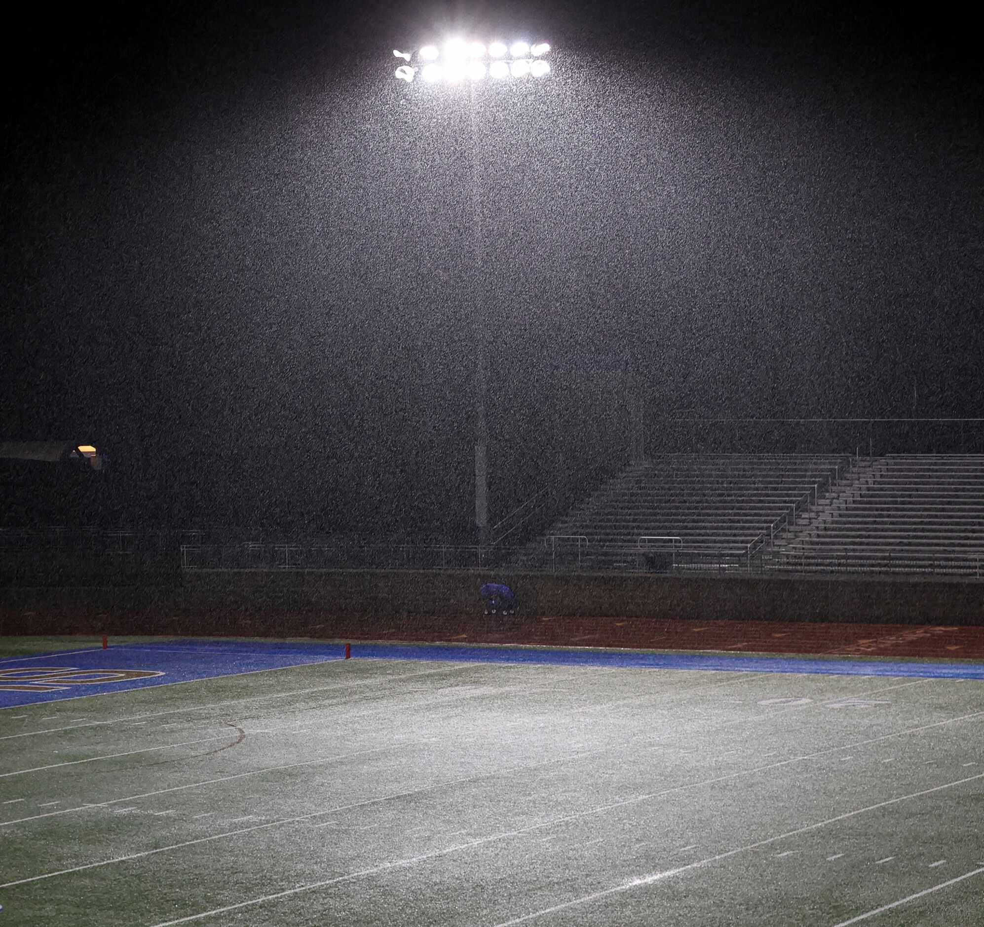 Heavy rain coming down at Rangers Stadium on the campus Jesuit College Preparatory School.  ...