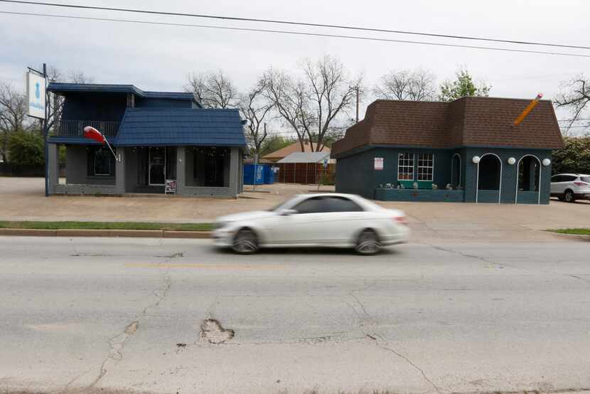 A motorist passes by two buildings on the 2000 block of North Henderson Avenue in Dallas on...