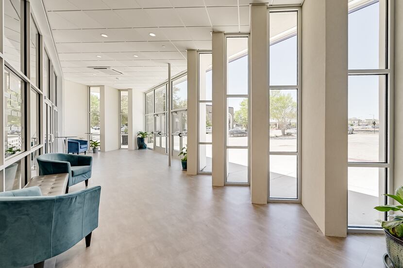 A view from Theatre Arlington's glassed-in foyer, with turquoise armchairs.