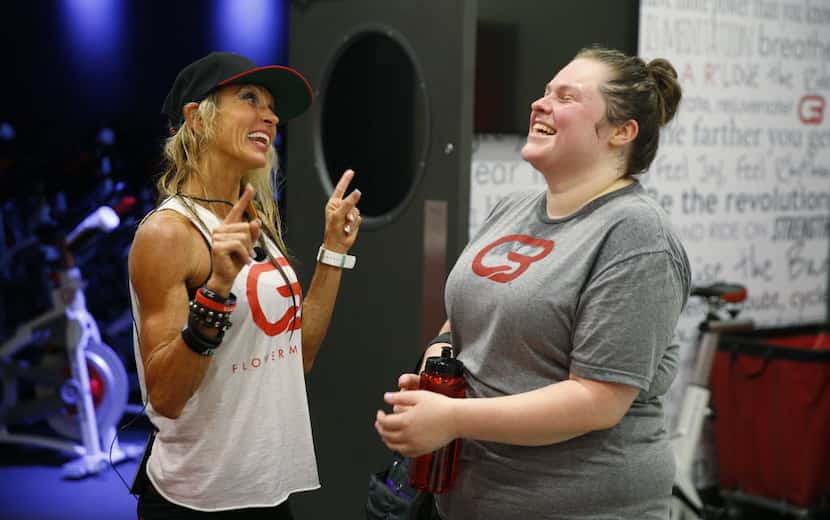Anja Taylor shares a laugh with Lynn Marsh, her cycle coach, after working out at CycleBar...