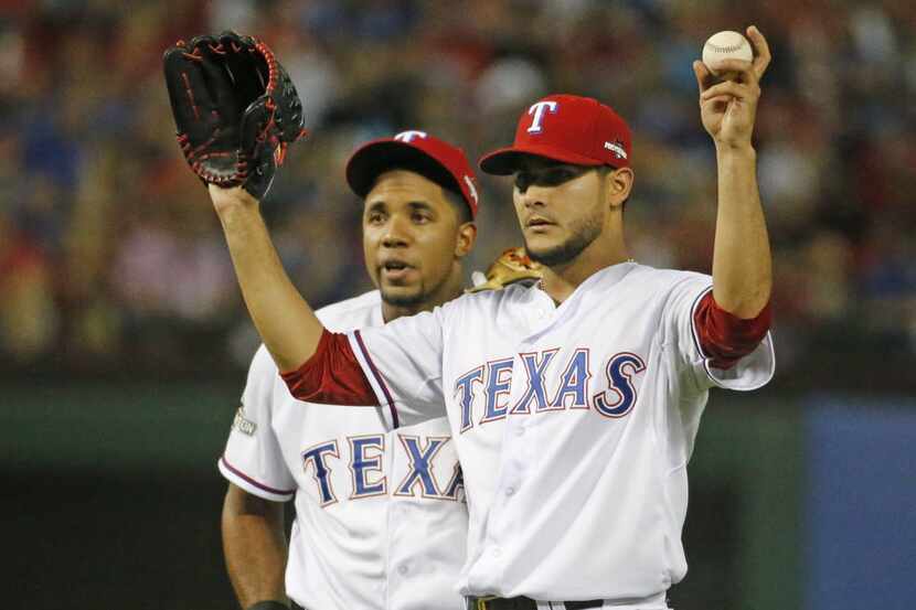 Texas Rangers shortstop Elvis Andrus, left, and pitcher Martin Perez are pictured during...