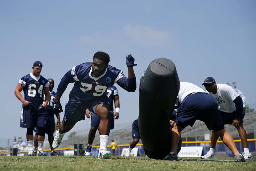 Dallas Cowboys defensive end Charles Tapper (79) works with a tackling dummy during a...