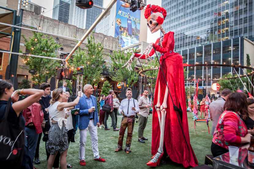 A tall skeleton-like figure walks among the partygoers at the Eye Ball Party celebrating the...